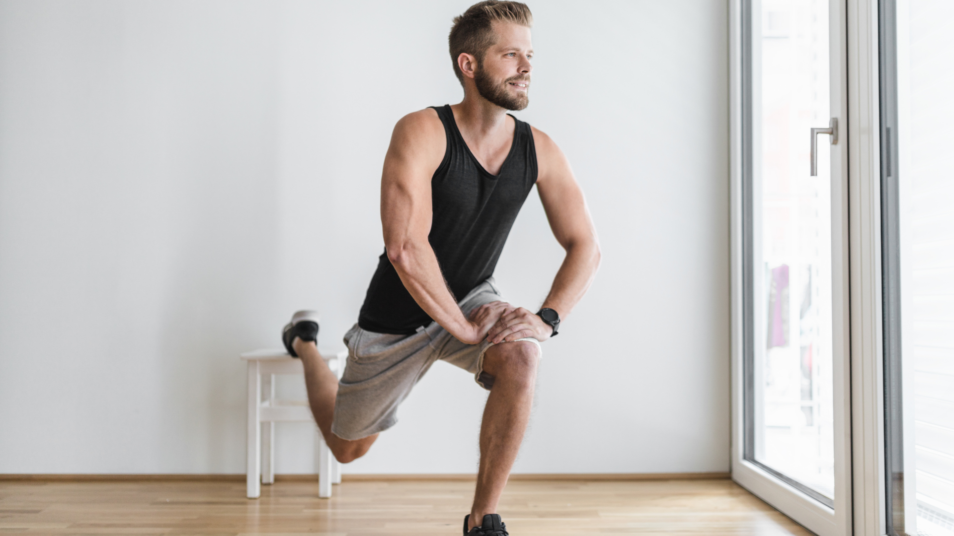 man doing an exercise infront of a large window